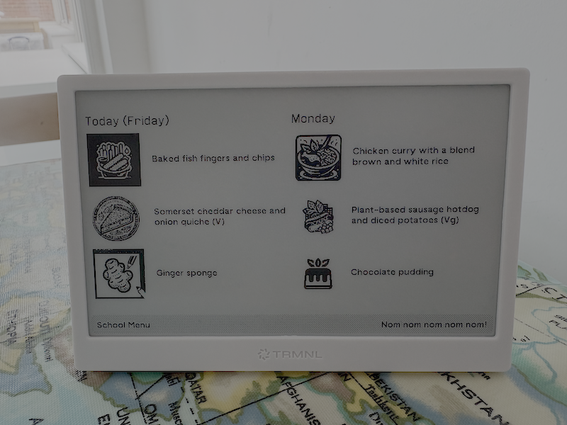 A photo of a TRMNL screen showing the meat, meat free and dessert options for Today(Friday) and Monday in the Hampshire Primary School Catering menu